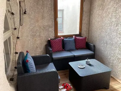 a small patio with two chairs and a table at Cœur d 'amande in Narbonne