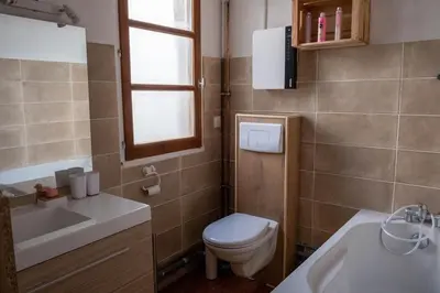 a bathroom with a toilet and a sink and a window at Cœur d 'amande in Narbonne
