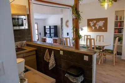 a kitchen with a counter and a dining room at Cœur d 'amande in Narbonne