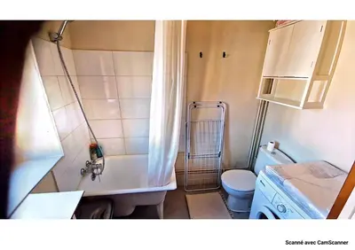 a bathroom with a tub and a toilet and a sink at Maison QUÉRIGUT in Quérigut
