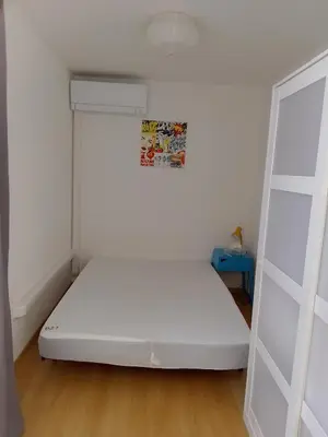 a bedroom with a white bed and a ladder at Appartement 6 personnes Gruissan in Gruissan