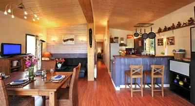 a dining room and kitchen with a table and chairs at Maison - piscine - Vue vignobles coeur de nature in Roquetaillade