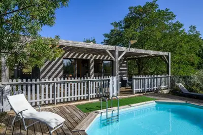 a house with a swimming pool and a white fence at Maison - piscine - Vue vignobles coeur de nature in Roquetaillade