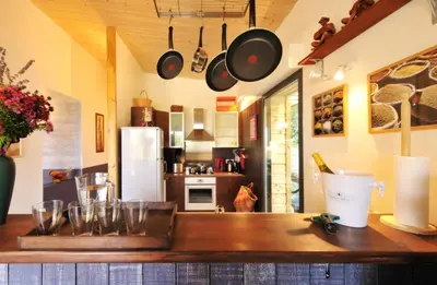 a kitchen with a wooden counter with pots and pans at Maison - piscine - Vue vignobles coeur de nature in Roquetaillade