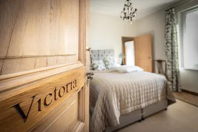 a bedroom with a bed and a wooden door at Maison du canal du midi in Carcassonne