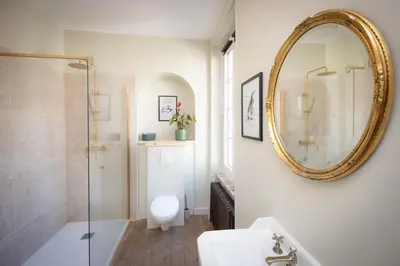 a bathroom with a toilet and a mirror on the wall at Maison du canal du midi in Carcassonne