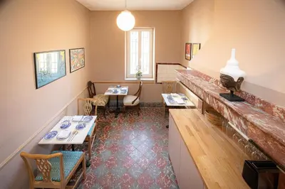 a restaurant with two tables and chairs in a room at Maison du canal du midi in Carcassonne
