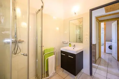 a bathroom with a sink and a shower at Ecolodge - Calme - Piscine privée - vue nature in Roquetaillade