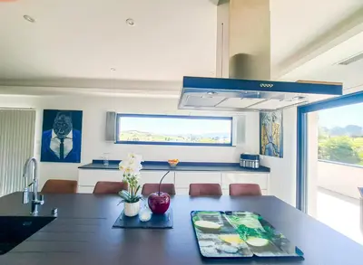a kitchen and dining room with a table and a sink at Villa d'artistes in Malras