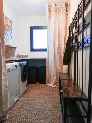 a kitchen with a washing machine and a window at Villa d'artistes in Malras