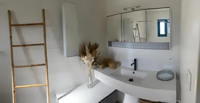 a white bathroom with a sink and a mirror at Villa d'artistes in Malras