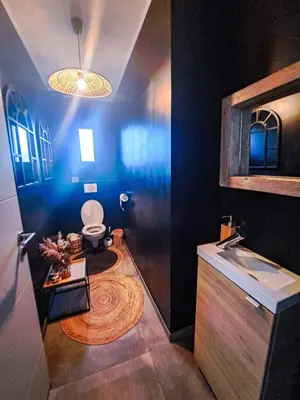 a bathroom with a toilet and a sink at Villa d'artistes in Malras