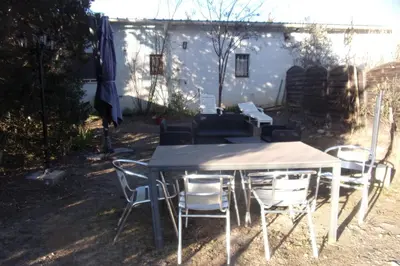 a table and chairs in front of a house at DOMAINE LE PLA de LIÉRE in Maury