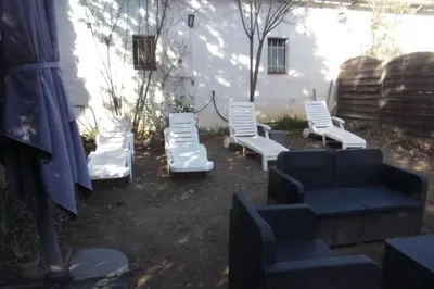 a group of white chairs sitting in a yard at DOMAINE LE PLA de LIÉRE in Maury