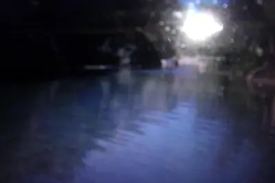 a street light over a body of water at night at DOMAINE LE PLA de LIÉRE in Maury