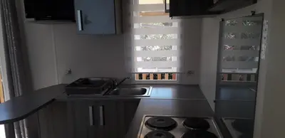 a kitchen with a sink and a stove at omer port la nouvelle in Port-la-Nouvelle
