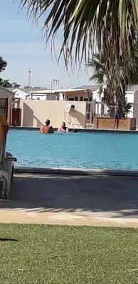 a group of people in a swimming pool with a frisbee at omer port la nouvelle in Port-la-Nouvelle