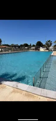 a large pool of blue water next to a pier at MOBIL HOME Le Soleil,3CH,6PERS in Port-la-Nouvelle