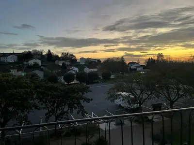 a view of a town at sunset from a balcony at Maison de Village in Lacrouzette