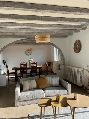 a living room with a couch and a table at Maison de Village in Lacrouzette
