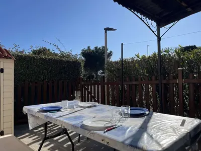 a white table with plates and glasses on it at Pavillon confort avec parking et piscine collective - GN180-057 in Gruissan