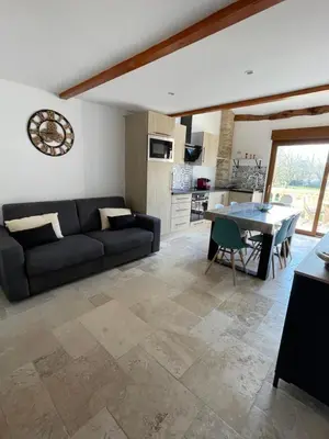 a living room with a couch and a table at studio cosy a la ferme in Saint-Julia