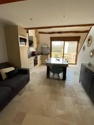 a living room with a couch and a table at studio cosy a la ferme in Saint-Julia