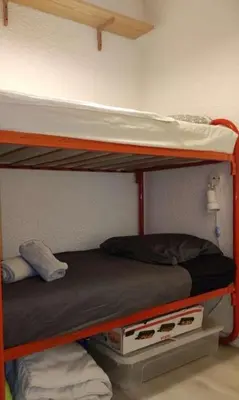 two bunk beds in a room with a bed at L'Escapade Marine in Gruissan