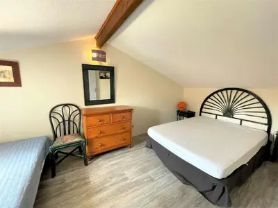 a bedroom with a bed and a dresser and a mirror at Maison front de plage avec terrasse Grazel - GN210-027 in Gruissan