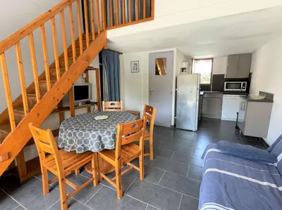a kitchen and dining room with a table and chairs at Maison front de plage avec terrasse Grazel - GN210-027 in Gruissan