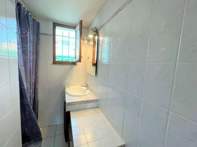 a bathroom with a sink and a mirror at Maison front de plage avec terrasse Grazel - GN210-027 in Gruissan