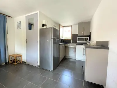 a kitchen with a stainless steel refrigerator and microwave at Maison front de plage avec terrasse Grazel - GN210-027 in Gruissan