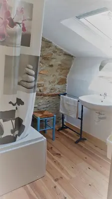 a bathroom with a sink and a table at la source et la sorciere in Pradelles-Cabardès