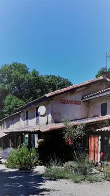 an old building with a sign on the side of it at la source et la sorciere in Pradelles-Cabardès