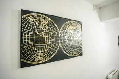 a framed picture of two world maps on a wall at Au pied des remparts- Maison de caractère-3 Ch-AC in Carcassonne