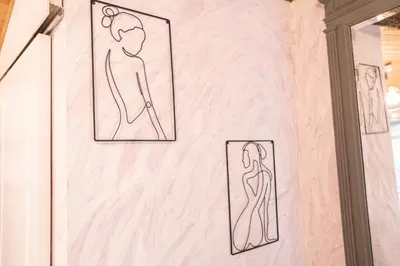 a wall with drawings of a woman in a mirror at Au pied des remparts- Maison de caractère-3 Ch-AC in Carcassonne