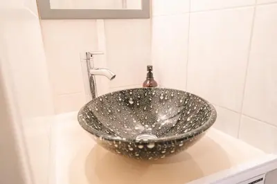 a bathroom sink with a silver bowl on a counter at Au pied des remparts- Maison de caractère-3 Ch-AC in Carcassonne