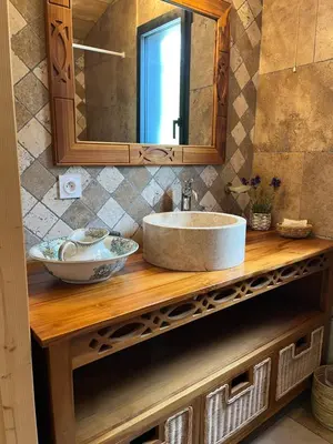 a bathroom counter with a sink and a mirror at Le Chalet in Fanjeaux