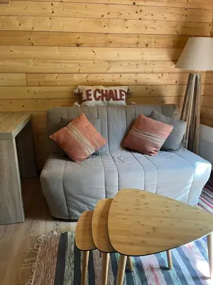 a living room with a couch and a table at Le Chalet in Fanjeaux