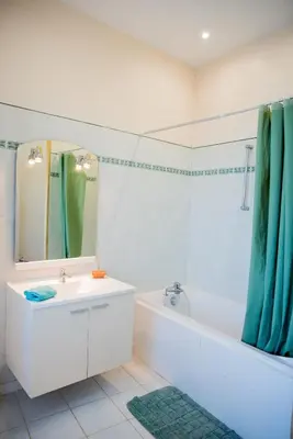 a bathroom with a sink and a tub and a mirror at Domaine de Gondal, demeure de charme in Palaja