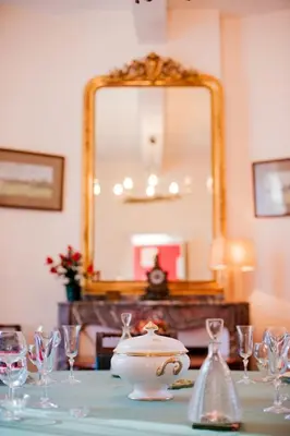 a table with a mirror and a bowl and glasses at Domaine de Gondal, demeure de charme in Palaja