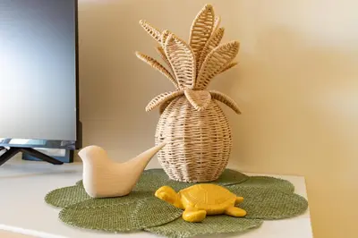 a toy turtle and a vase on a table at Les Jacinthes - Spacious sea view in Port-la-Nouvelle