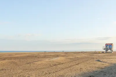 a lifeguard station on a beach with the ocean in the background at Les Jacinthes - Spacious sea view in Port-la-Nouvelle