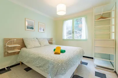 a bedroom with a bed with a stuffed animal on it at Les Jacinthes - Spacious sea view in Port-la-Nouvelle