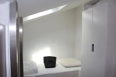 a small room with a bed and a bag at Maison 2 pièces mezzanine - Gruissan GN020-071 in Gruissan