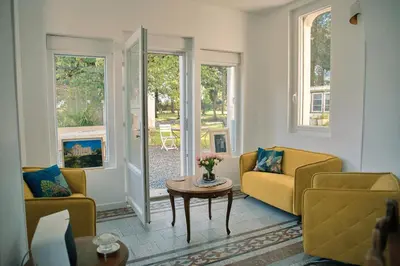 a living room with two couches and a table at Le Château de La Seigne près de Carcassonne in Villemoustaussou