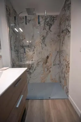 a bathroom with a shower with a marble wall at Le Château de La Seigne près de Carcassonne in Villemoustaussou