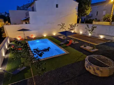 a backyard with a swimming pool at night at Charming Master House with Private Pool in Quarante