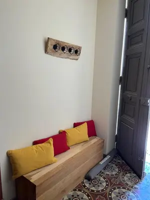 a room with a bench with yellow and red pillows at Charming Master House with Private Pool in Quarante
