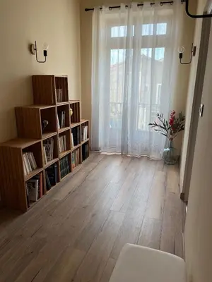 a living room with a large window and a wooden floor at Charming Master House with Private Pool in Quarante